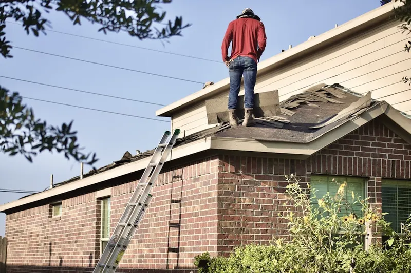Professional roofer working on a residential roof in Calvert